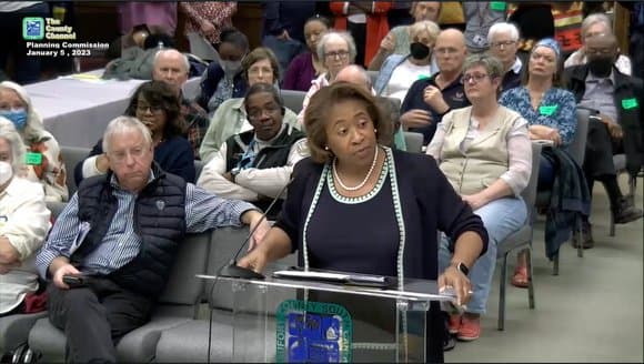 Faith Rivers James speaking at a podium during a public planning commission meeting